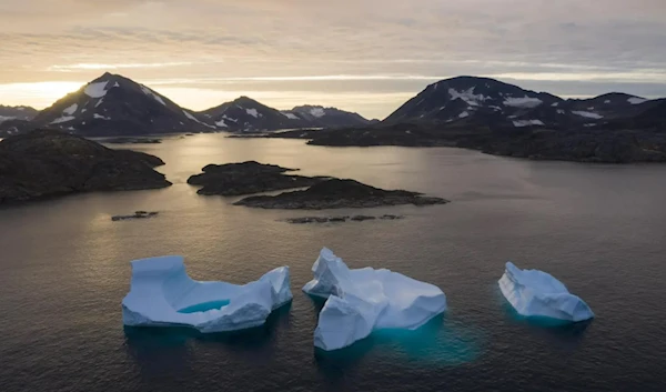 Large icebergs float away as the sun rises near Kulusuk, Greenland, August 26, 2019.  (AP)