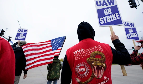 Members of the United Auto Workers strike outside of a John Deere plant, Wednesday, Oct. 20, 2021, in Ankeny, Iowa. (AP)