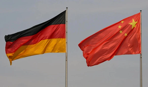 The German flag is seen next to the Chinese Flag. (AFP)