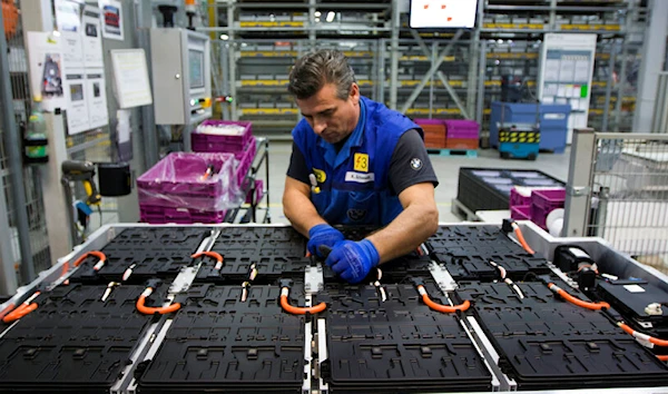 BMW employee Kamer Schmidt works at the production line for electric drive modules for BMW i8 plug-in hybrid cars and i3 electric drive cars in Dingolfing, Germany, Tuesday, Jan. 20, 2015. (AP Photo/Matthias Schrader)