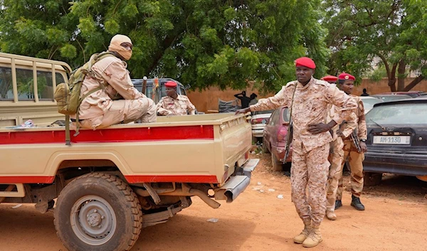 Nigerien national guardsmen sit outside the customs offices in Niamey, Niger, Monday, Aug. 21, 2023 (AP Photo/Sam Mednick)