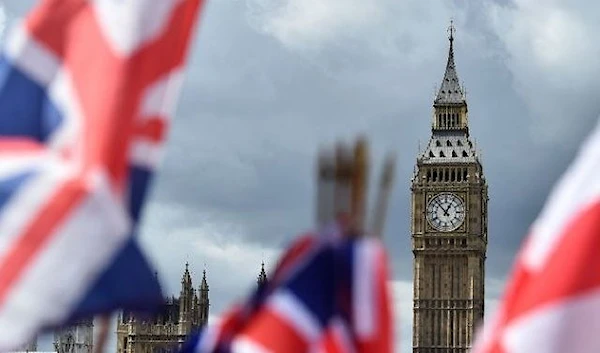 National flags flutter near the The Elizabeth Tower, commonly referred to as Big Ben, in central London on June 9, 2017 (AFP)