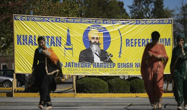 A photograph of late Hardeep Singh Niijar is seen on banner in Surrey, British Columbia on Monday September 18, 2023. (AP)