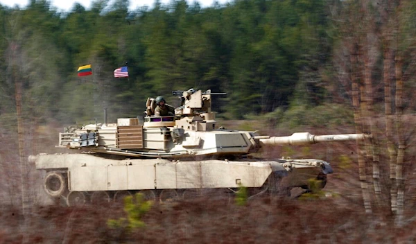 U.S. soldiers from the 2nd Battalion, 1st Brigade Combat Team, 3rd Infantry Division ride on an M1A2 Abrams battle tank during a military exercise at the Gaiziunu Training Range in Pabrade some 60km (AP Photo/Mindaugas Kulbis)