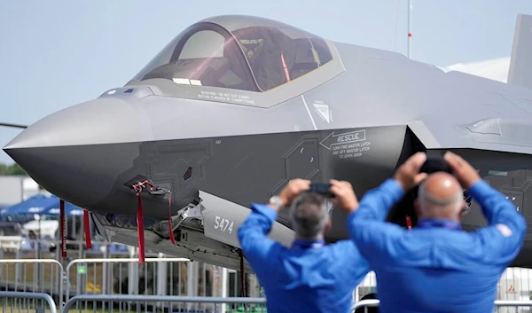 Visitors take pictures of a F35 Lightning 2 fighter plane at the Farnborough Air Show fair in Farnborough, England, Monday, July 18, 2022 (AP)