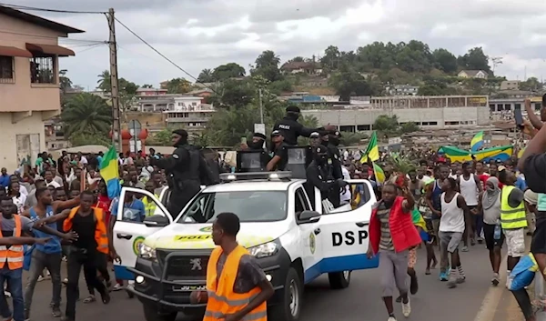 This video grab shows coup supporters cheering police officers in Libreville, Gabon, on Aug. 30, 2023. (AP)