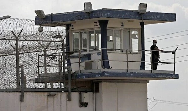 An Israeli police officer keeps watch from an observation tower at the Gilboa Prison in northern occupied Palestine on September 6, 2021 (AFP)