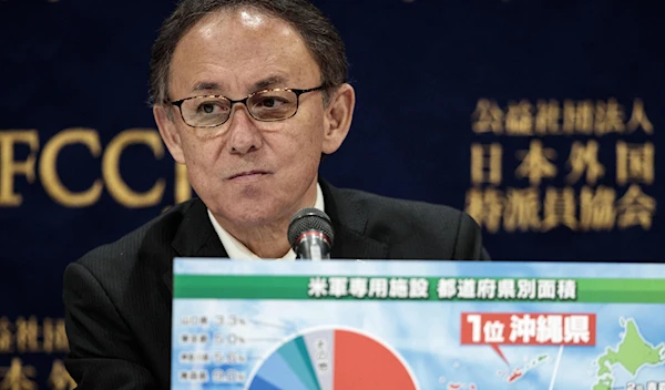 Okinawa Governor Denny Tamaki shows a board, displaying statistics of US military bases in Japan including Okinawa, during a press conference in Tokyo on March 1, 2019, after a vote on the relocation of a US base on the island on February 25. (AFP)