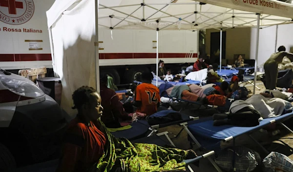 Migrants try to sleep outside on Lampedusa Island, Italy, Sept. 14, 2023. (AP)