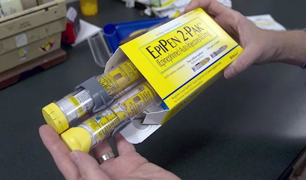 Pharmacist Clint Hopkins, owner of Pucci's Pharmacy, displays a package of EpiPens, an epinephrine autoinjector for the treatment of allergic reactions, in Sacramento, California, US (AP)