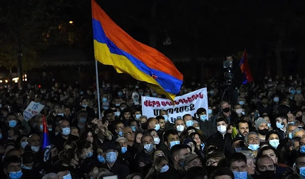 Armenians rally to demand Prime Minister Nikol Pashinyan’s resignation in Yerevan on November 8, 2021, a year after Pashinyan signed a Russian-brokered ceasefire agreement with Azerbaijan. (AP)