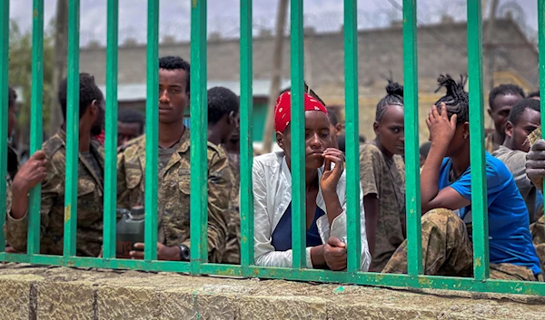 Members of the Ethiopian National Defense Force who were captured by Tigray forces look out from the gate of a prison where they are now held as prisoners of war, in Mekele, in the Tigray region of northern Ethiopia on Tuesday, July 6, 2021. (AP)