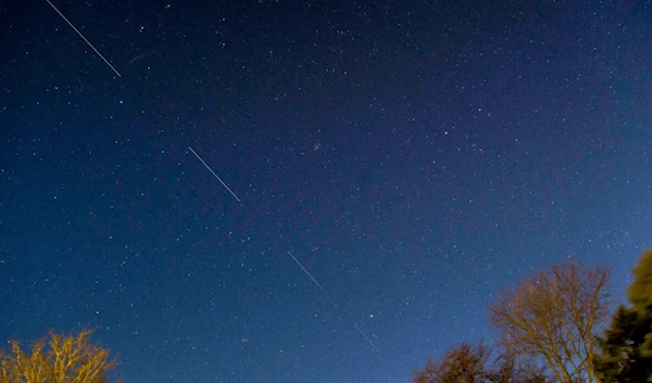 A SpaceX Starlink satellite is seen passing in the night sky. April 2020 (AFP)