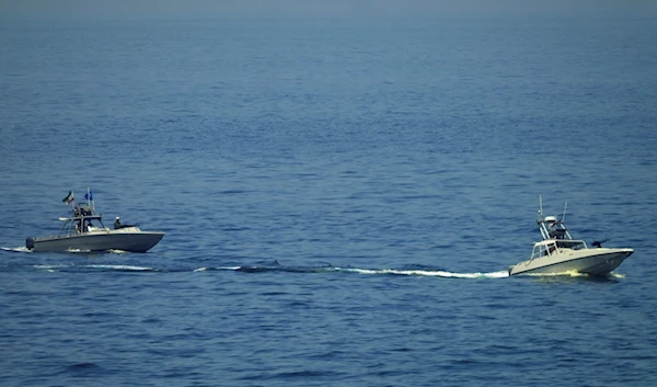 Iranian IRGC vessels watch an American warship in the Strait of Hormuz Friday, May 19, 2023 (AP Photo/Jon Gambrell)