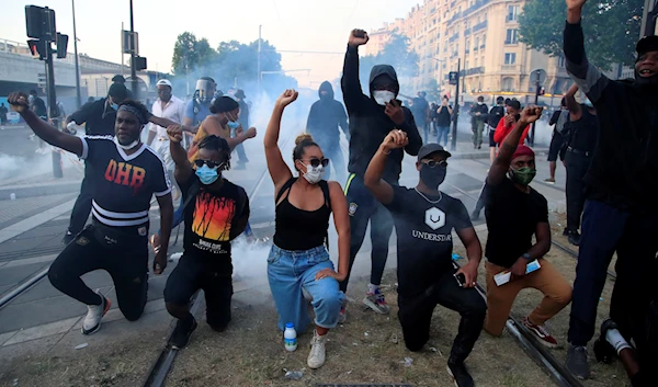 Protesters gesture during a demonstration against police violence and racial injustice, Tuesday, June 2, 2020, in Paris (AP)