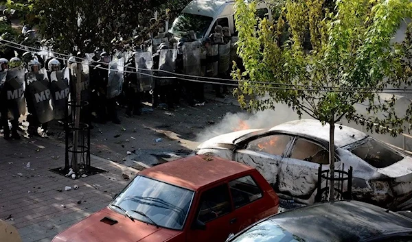 Kosovo riot police and KFOR (International Military Mission to Kosovo) military police, secure entrance to municipal building in Zvecan, northern Kosovo on May 29, 2023. (AFP)