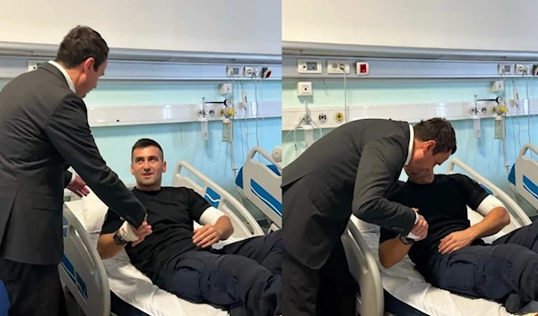 Another police officer who was involved in the attack and survived injuries is seen shaking hands with the Prime Minister of Kosovo. (X, formerly Twitter)