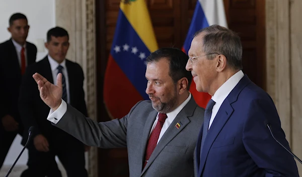 Venezuela's Foreign Minister Yvan Gil, left center, and Russia's Foreign Minister Sergei Lavrov, talk after a press conference at the Foreign Ministry in Caracas, Venezuela, Tuesday, April 18, 2023. (AP)