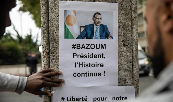 Demonstrators gather in front of the Embassy of Niger in Paris, in support of Nigerien President Mohamed Bazoum and ECOWAS, Saturday, Aug. 5, 2023. (AP)