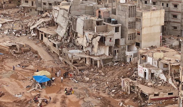 Rescuers and relatives of victims set up tents in front of collapsed buildings in Derna, Libya, Monday, Sept. 18, 2023.