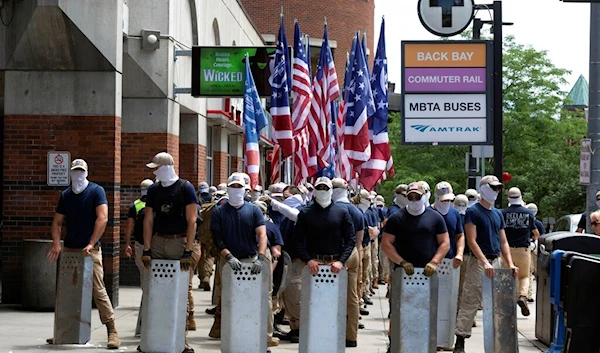 Marchers bearing insignias of the white supremacist group Patriot Front pause during a gathering on Saturday, July 2, 2022, in Boston (AP)