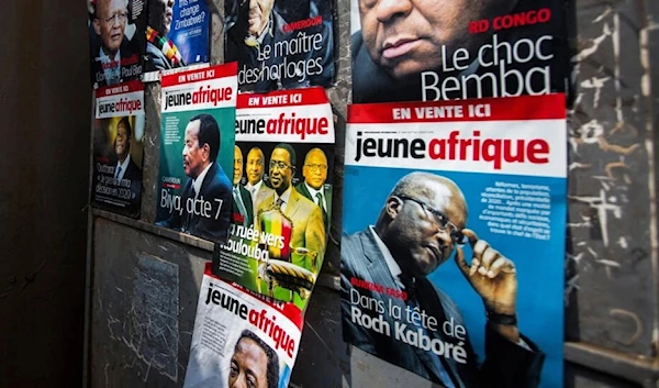 Posters advertising French newspaper 'Jeune Afrique' is plastered on a wall in downtown Kigali on August 2, 2018 (AFP)