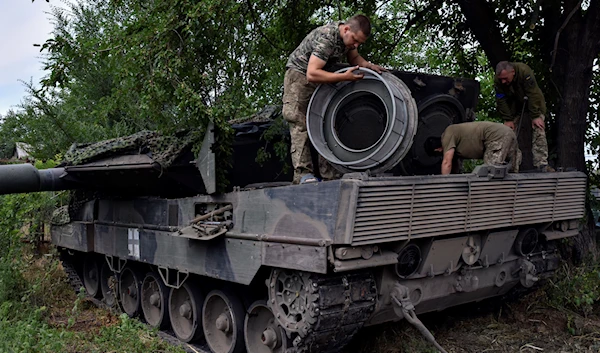 Ukrainian soldiers repair a Leopard 2 tank in Zaporizhzhia region, Ukraine, on June 21, 2023 (AP)