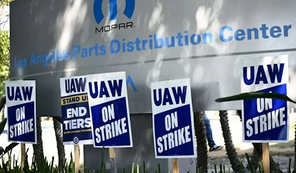 “UAW ON STRIKE” signs stand as members of the United Auto Workers Local 230 union hold a picket line outside the Stellantis Chrysler Los Angeles Parts Distribution Center in Ontario, California, on Sept. 26, 2023. (AFP via Getty Images)