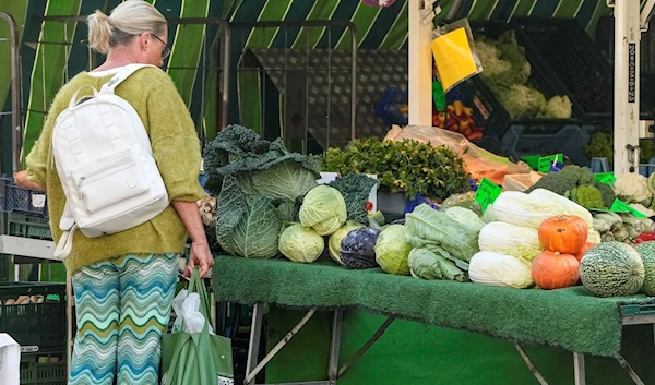 Traders present their goods at a weekly market in Gelsenkirchen, Germany, Thursday, Sept. 28, 2023 (AP)