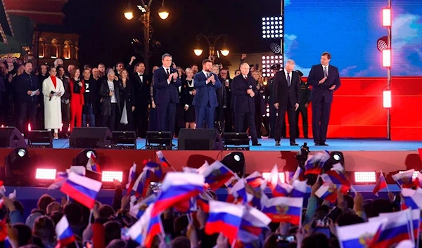 Russian President Vladimir Putin speaks as Leonid Pasechnik, head of Kherson Region Vladimir Saldo, head of Zaporozhye region Yevgeny Balitsky, during celebrations marking the reunification of the regions to join Russia, Moscow, Sept. 30, 2022. (AP)