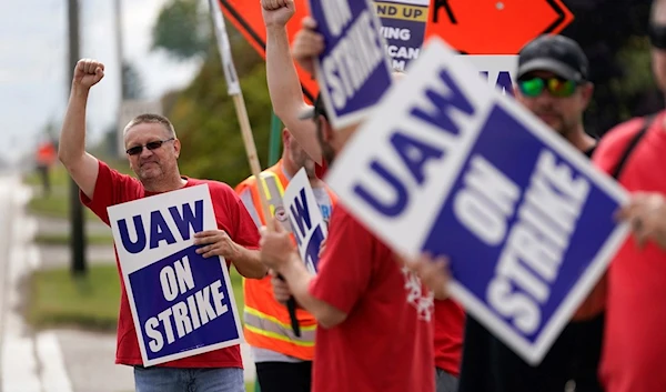 United Auto Workers member Mariusz Mirek holds a picket sign near a General Motors Assembly Plant in Delta Township, Mich., Friday, Sept. 29, 2023. (AP)