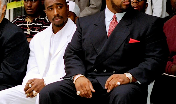 In this Aug. 15, 1996, file photo, rapper Tupac Shakur, left, and a founder of Death Row Records, Marion "Suge" Knight, attend a voter registration event in South Central Los Angeles (AP)