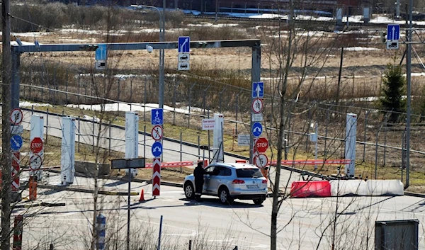 A Russian border guard officer checks a car at Pelkola border crossing point in Imatra, south-eastern Finland, Friday, April 14, 2023. (AP)