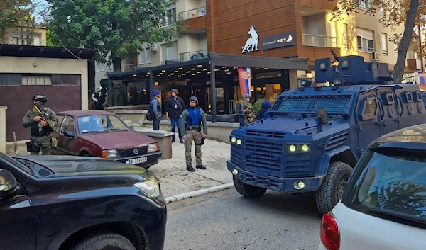 Kosovo police officers search restaurant and building in northern Serb-dominated part of ethnically divided town of Mitrovica, Kosovo, Friday, Sept. 29, 2023. (AP)