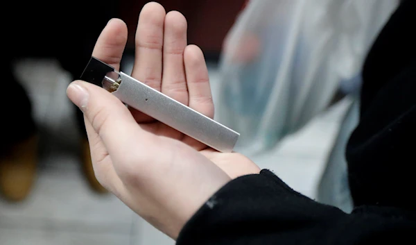 A man displays his Juul electronic cigarette while shopping at a convenience store in Hoboken, N.J., Thursday, Dec. 20, 2018. (AP)