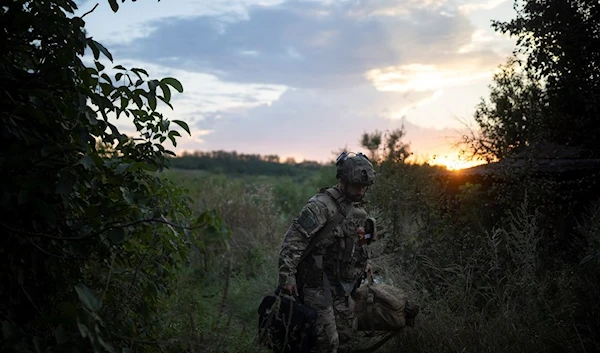 A Ukrainian soldier of the elite drone unit packs up after an attack on the front line in the outskirts of Kremennaya, Ukraine, Sunday, August 20, 2023 (AP)