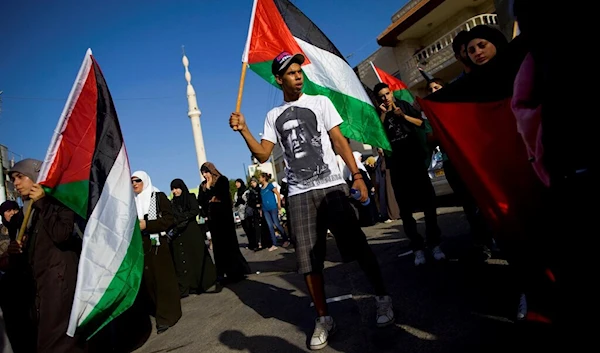 Palestinians participate in a rally marking 10 years since the start of the second Intifada, in Kafar Kana, in northern occupied Palestine, Friday, Oct. 1, 2010 (AP)