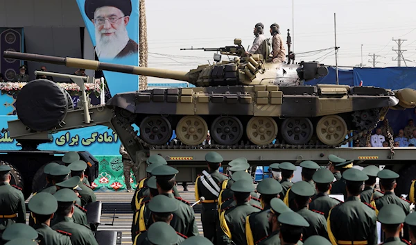 IRGC military parade commemorating the anniversary of the start of the Iraq-Iran war passes by portrait of Supreme leader, Sept. 22, 2022 (AP)