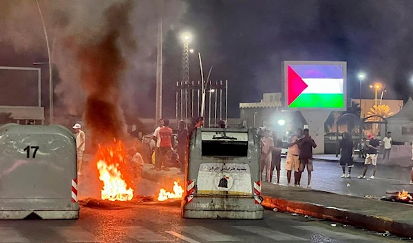 People attend a protest against the meeting between Israeli Occupation Foreign Minister Eli Cohen and his Libyan counterpart Najla al-Manqoush in Tripoli, Libya, Monday, Aug. 28, 2023. (AP)