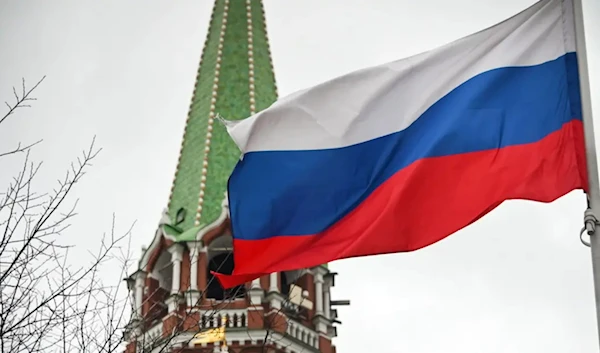 A Russian flag waves next to one of the Kremlin towers in downtown Moscow on February 26, 2022. (AFP)