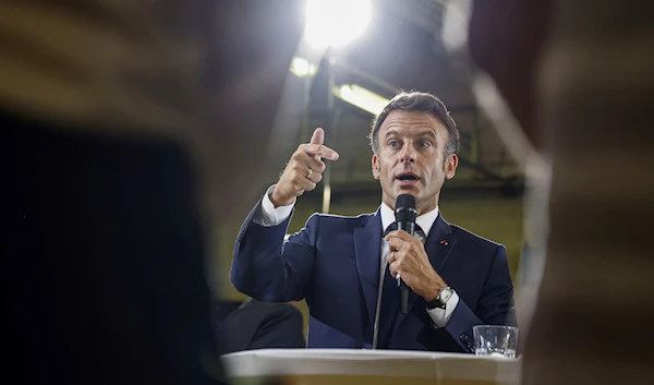 French President Emmanuel Macron gestures as he speaks to teachers during a visit to a vocational school in Orange, Southeastern France, Sept. 1, 2023 (AP)