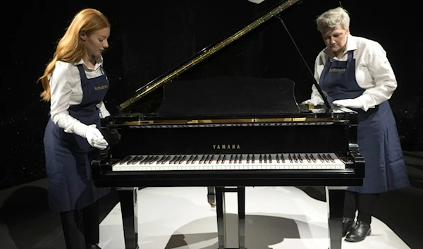 Freddie Mercury's Yamaha grand baby piano is estimated to cost 2-3 million pounds, on display at Sotheby's auction rooms in London, Aug. 3, 2023. (AP)