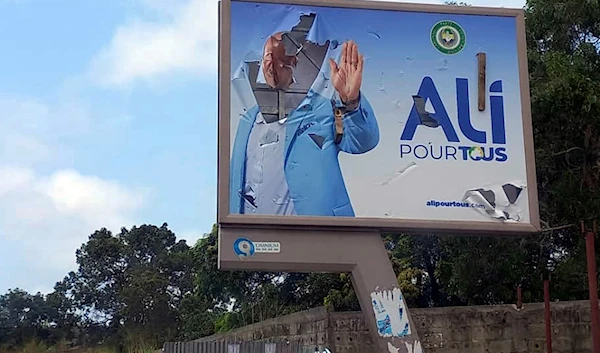 A defaced billboard of ousted President Ali Bongo Ondimba is seen on an empty street in Libreville, Gabon, Wednesday Aug. 30, 2023 (AP)