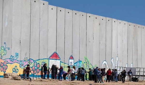 A graffiti on the Separation Wall near the border between Israeli illegal settlements and the Gaza Strip on Feb. 7, 2017. (AFP via Getty Images)