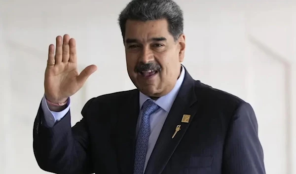 Venezuela’s President Nicolas Maduro waves upon arrival for the South American Summit at Itamaraty palace in Brasilia, Brazil, on May 30, 2023. (AP)