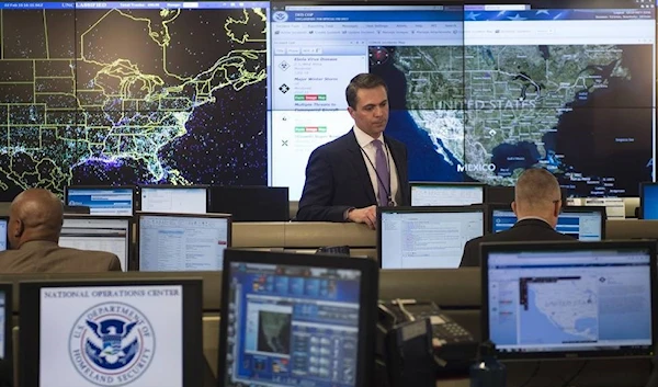 An employee sits at his computer terminal within the National Operations Center (NOC) at the Department of Homeland Security in Washington, DC, February 2, 2015. )AFP via Getty Images)