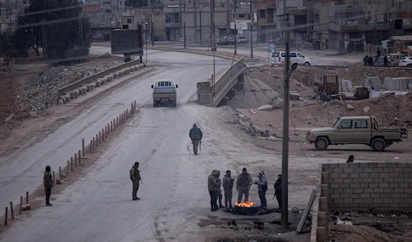 Fighters with the Kurdish-led Syrian Democratic Forces man a checkpoint in Hassakeh, northeast Syria, Jan. 24, 2022 (AP)