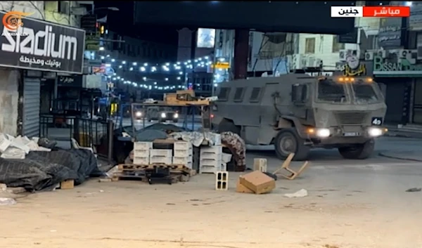 An Israeli troop carrier as part of military reinforcements storms the center of the city of Jenin, in the northern West Bank, at dawn on Wednesday (Al-Mayadeen Exclusive)