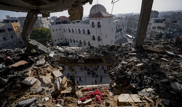 Palestinians look at a damaged residential building after an Israeli strike in Rafah, southern Gaza Strip, Wednesday, Jan. 10, 2024 (AP Photo/Fatima Shbair)