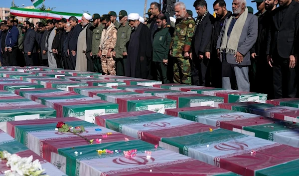 Iranians pray over the flag-draped coffins of victims of the terrorist attack during their funeral ceremony in the city of Kerman southeast of the capital Tehran, Iran, Friday, Jan. 5, 2024 (AP)